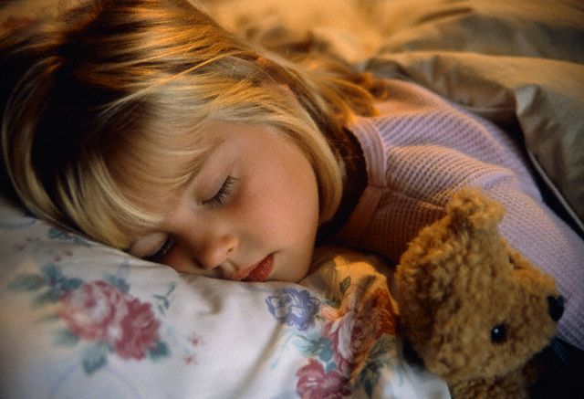 Girl Sleeping with Teddy Bear in Bed