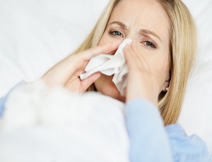 Closeup of a young woman having cold